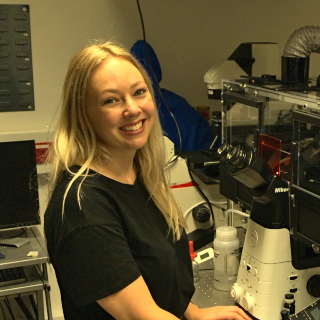 Katrina Wesencraft smiling at the camera while operating machinery