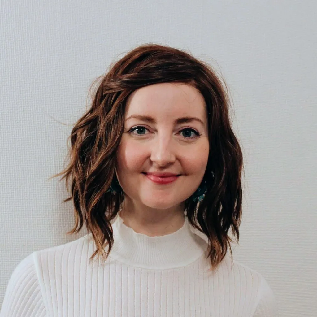 Kirsty Mills smiling at the camera, against a plain background