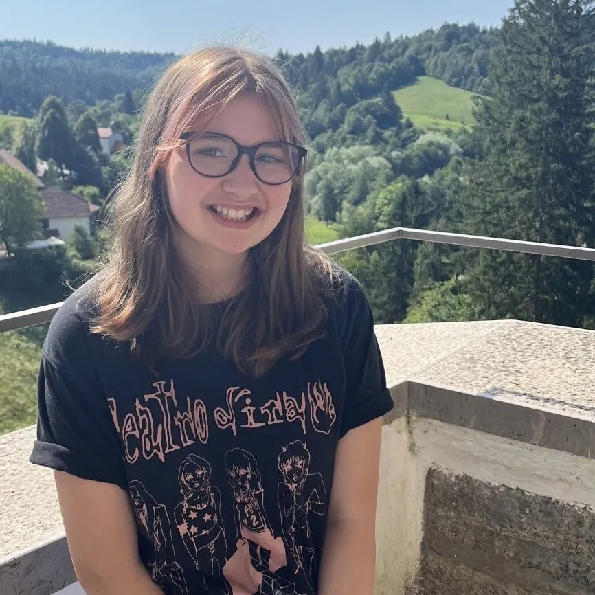 Elsie smiling at the camera at a viewpoint.