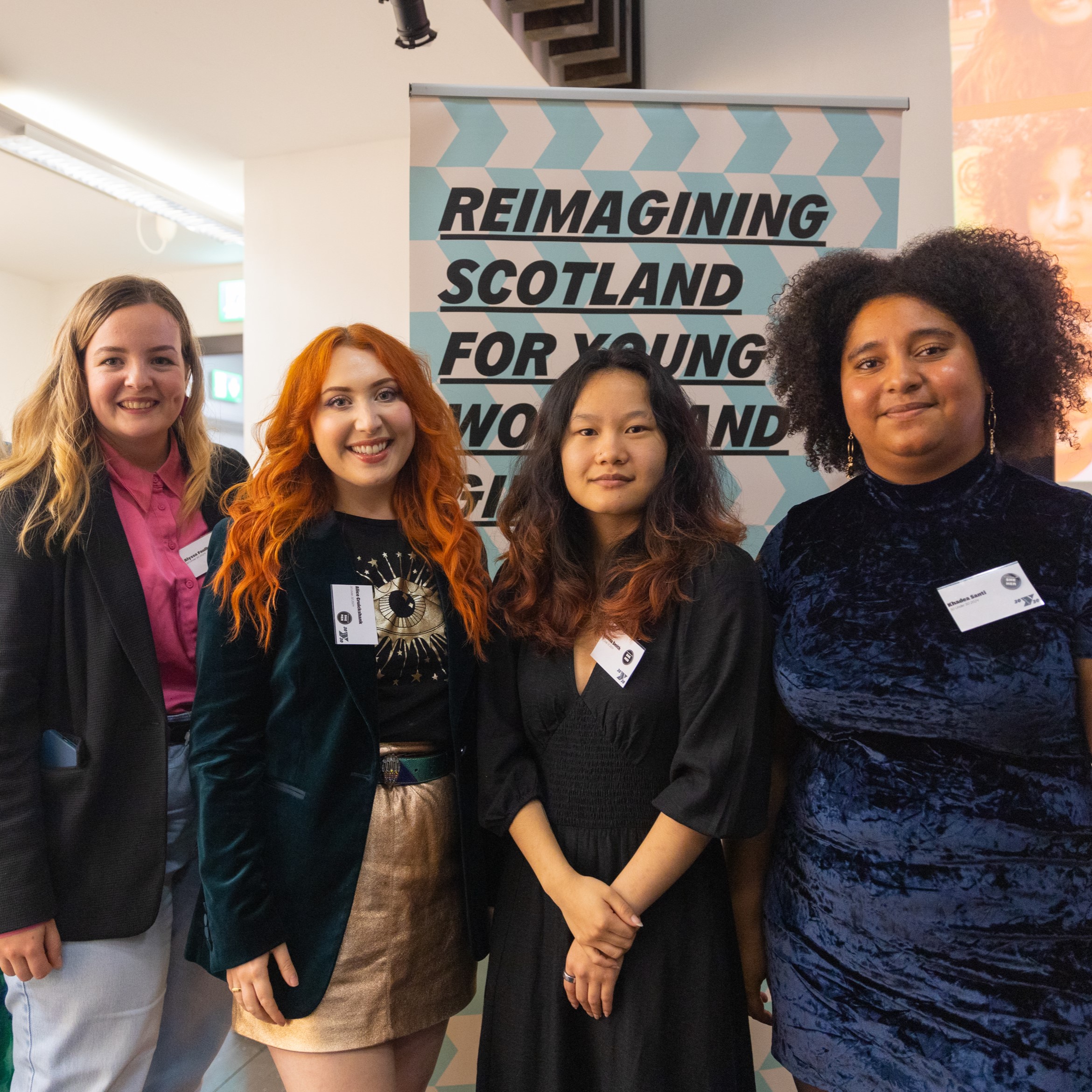 Four women smiling at the camera