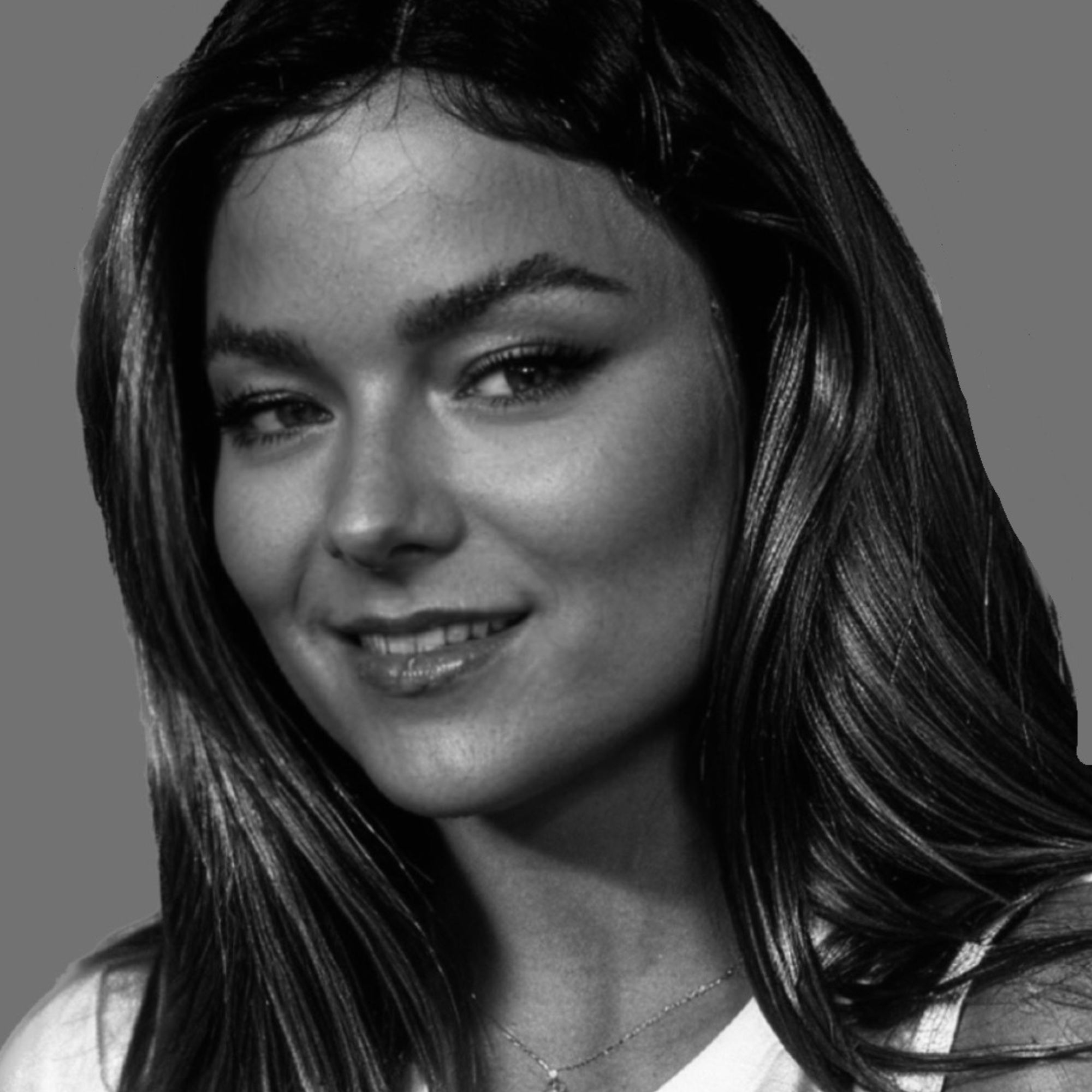 Black and white photo of Rebekah who has long hair and is smiling at the camera.