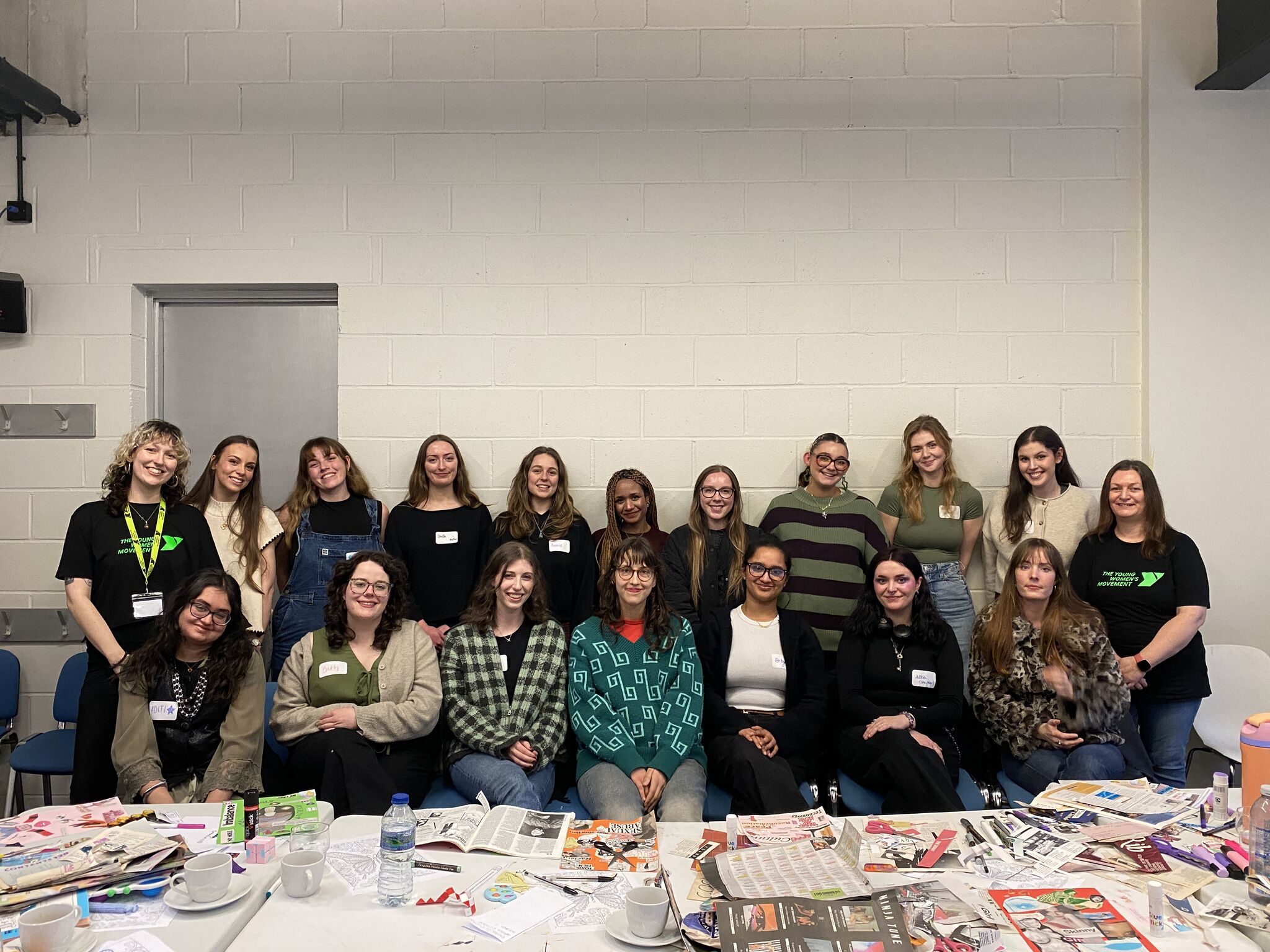 Our Young Women Lead AI group are diverse and smiling young women with crafts in front of them.