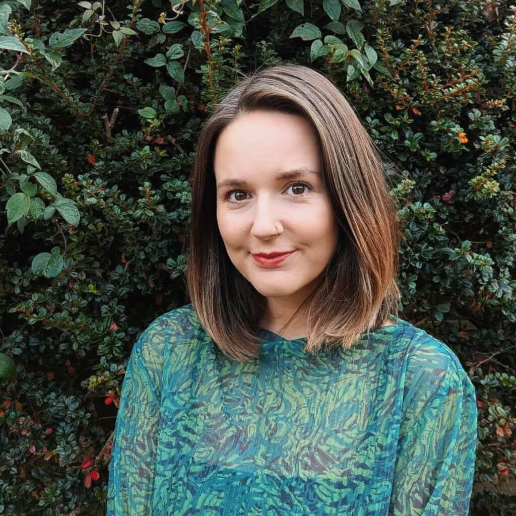 Ainya has pale skin and dark hair.