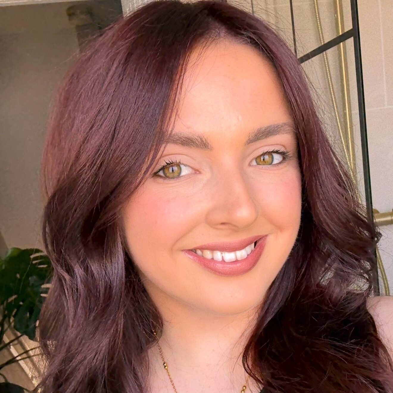 Toni has pale skin and long dark hair.