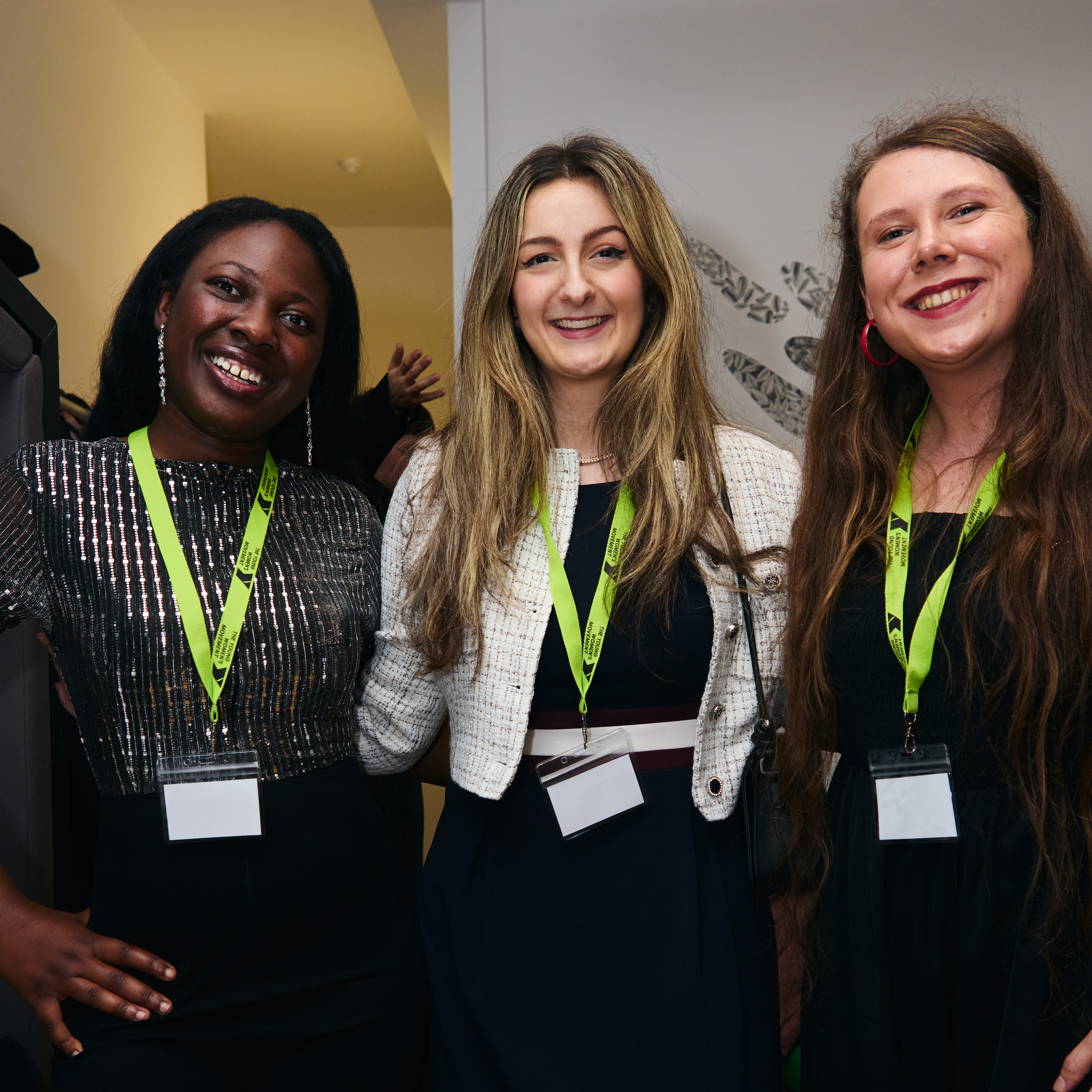 Favour, Tamara and Lucy from 30 Under 30 2025 smiling at the camera with YWM lanyards on