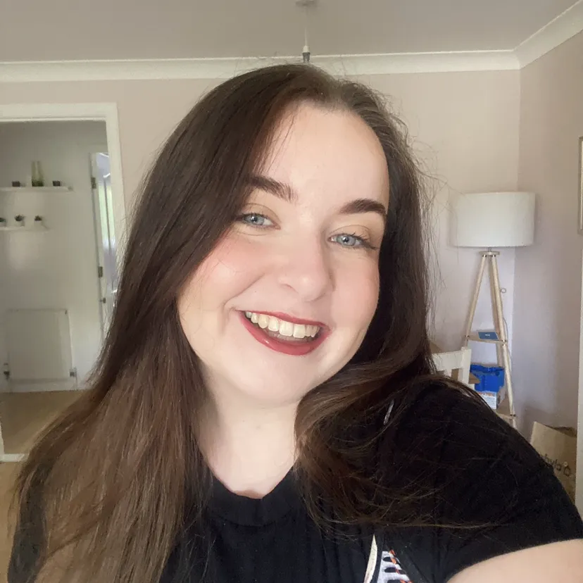 Sam has long dark hair, pale skin and blue eyes.