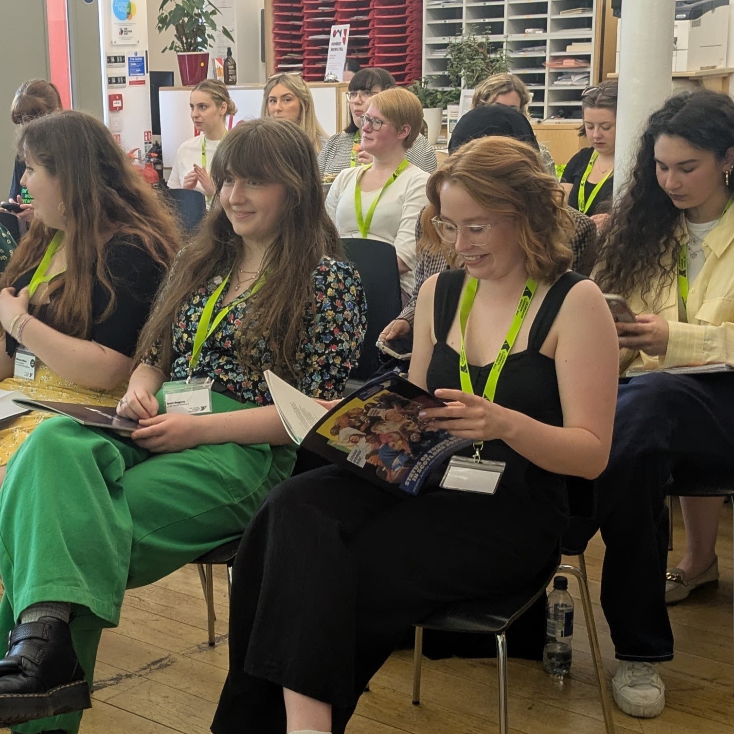 Young women reading copies of our latest research report