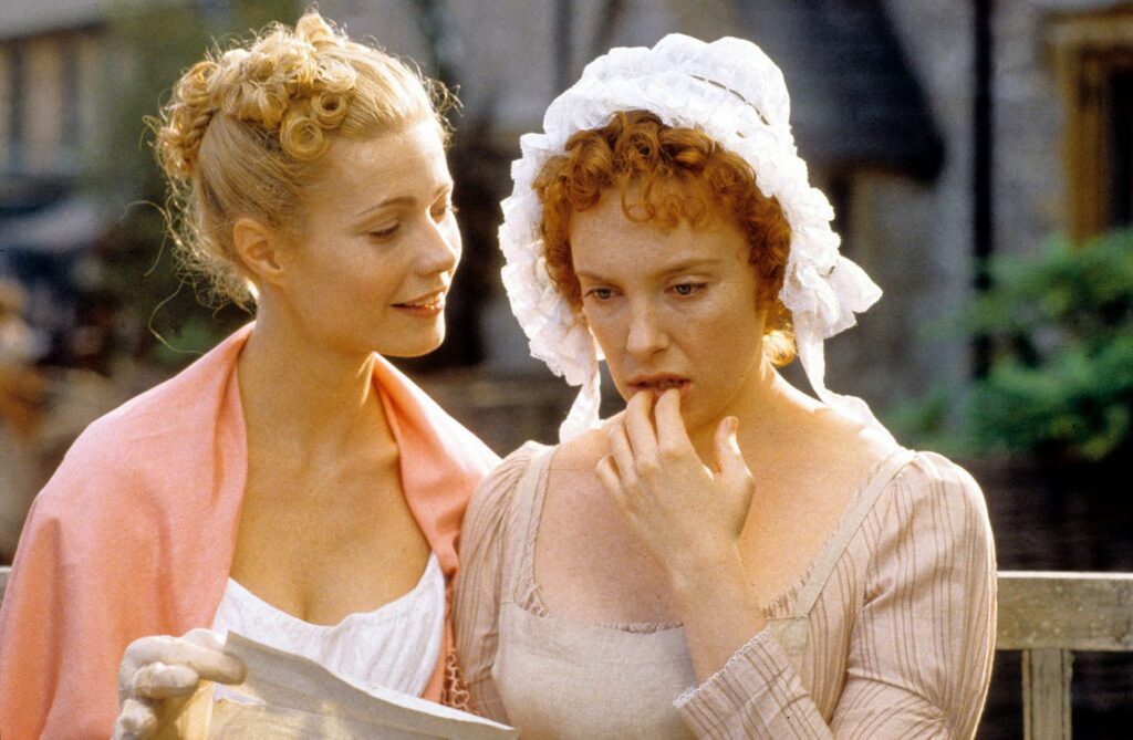 Still from Emma (1996), Emma is a blonde woman reading a letter, and Harriet has red hair and looks shocked.