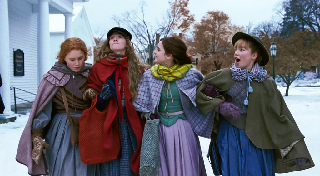 A still from Little Women (2019) showing the March sisters in the snow, laughing together.