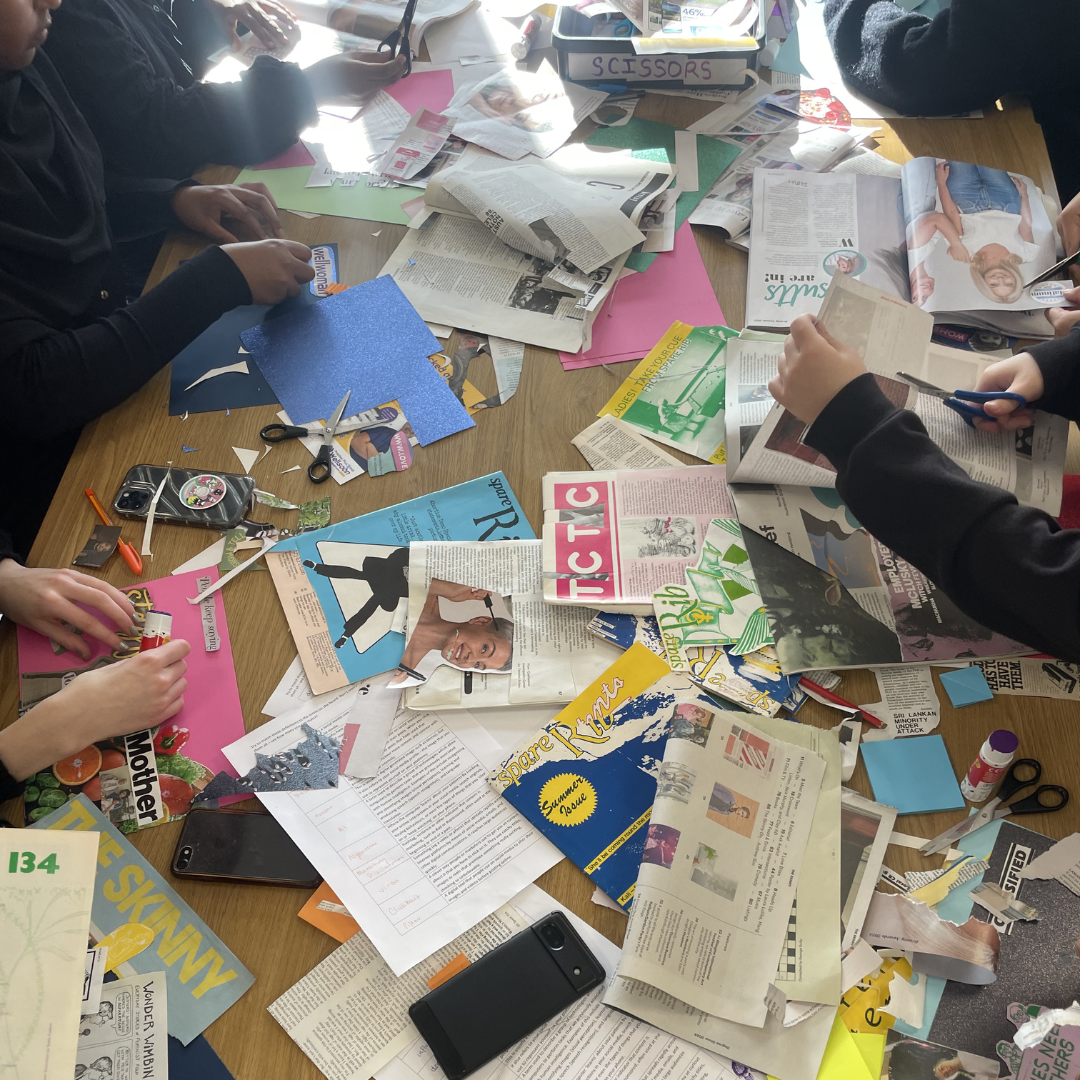 Zine making session with girls cutting up magazines.